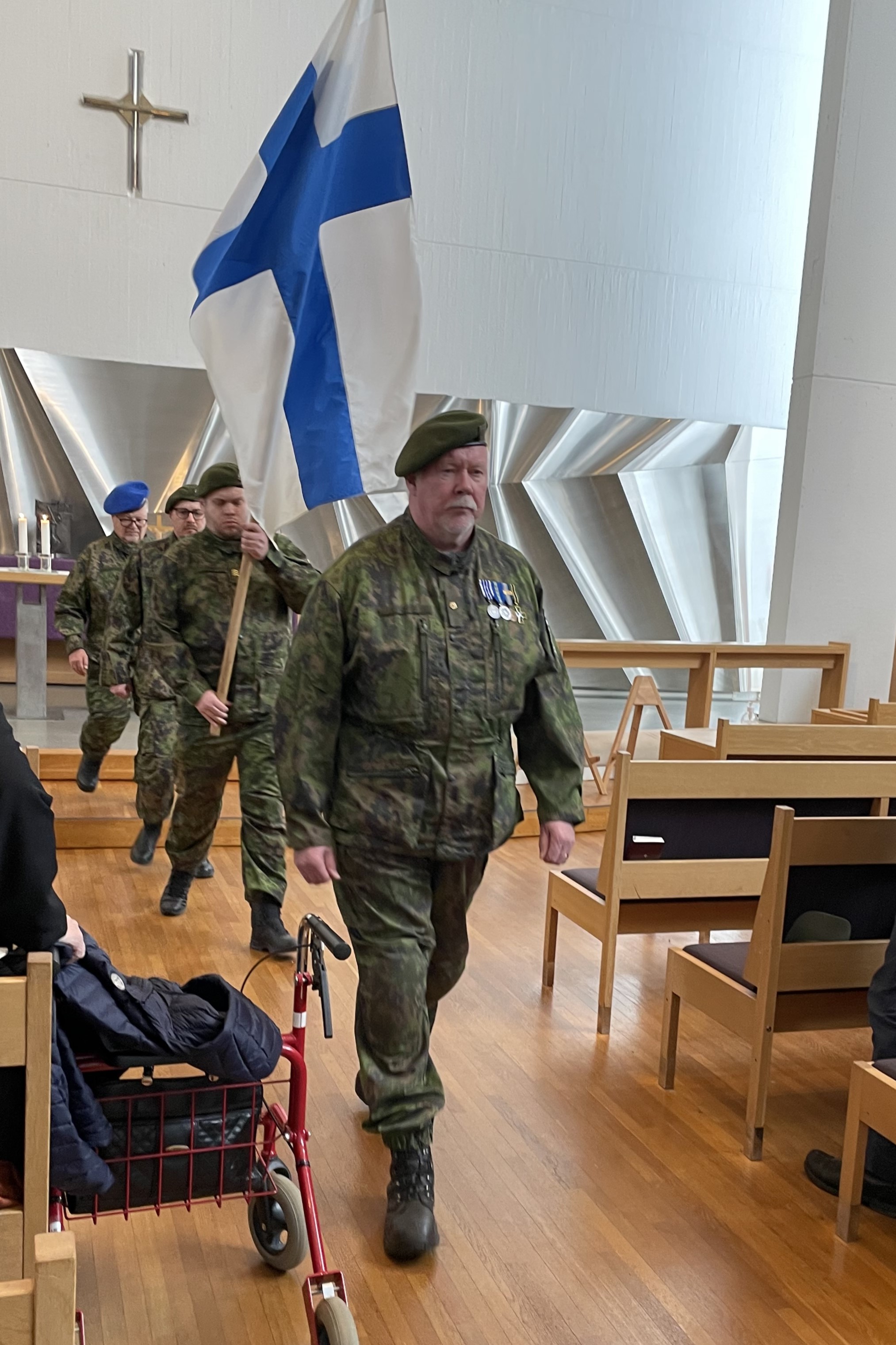 Suomen lippu poistuu kirkosta.